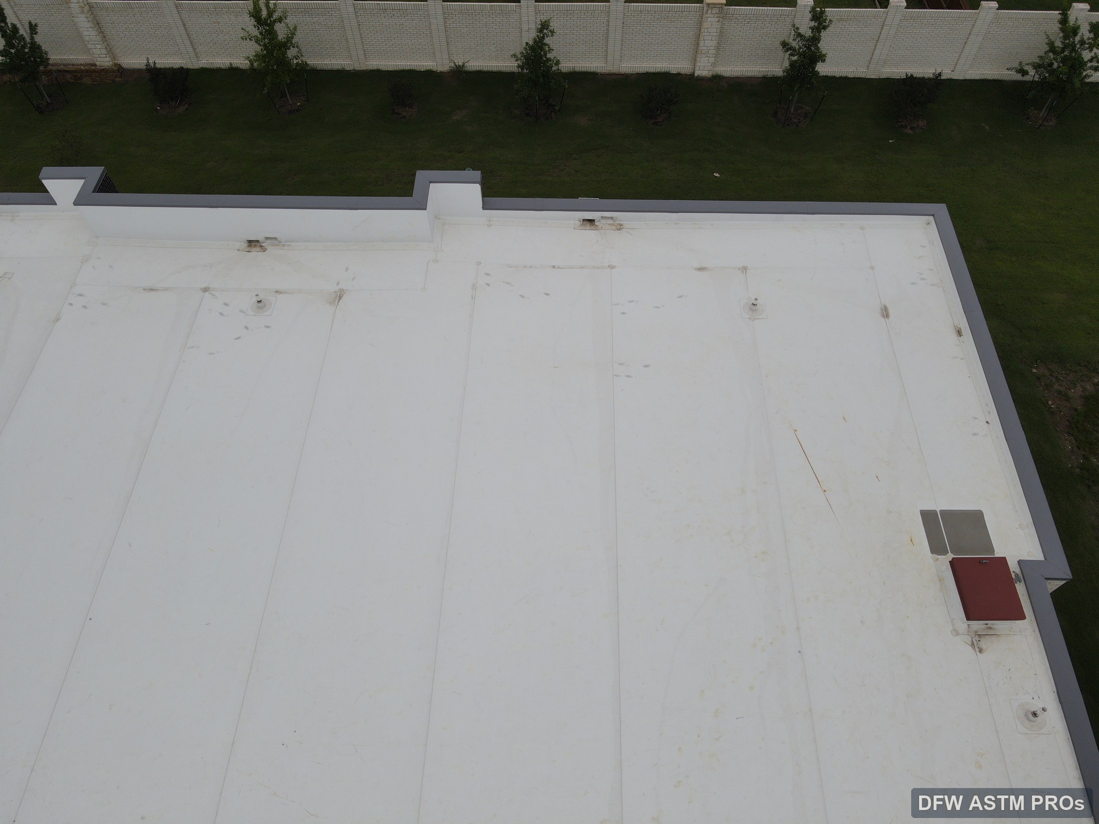 Visible aerial view showing scuppers along the TPO roof parapet