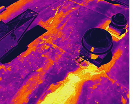 Close aerial infrared view of a TPO restaurant roof in Winnsboro, Texas, showing a pronounced thermal pattern near restaurant exhaust equipment.